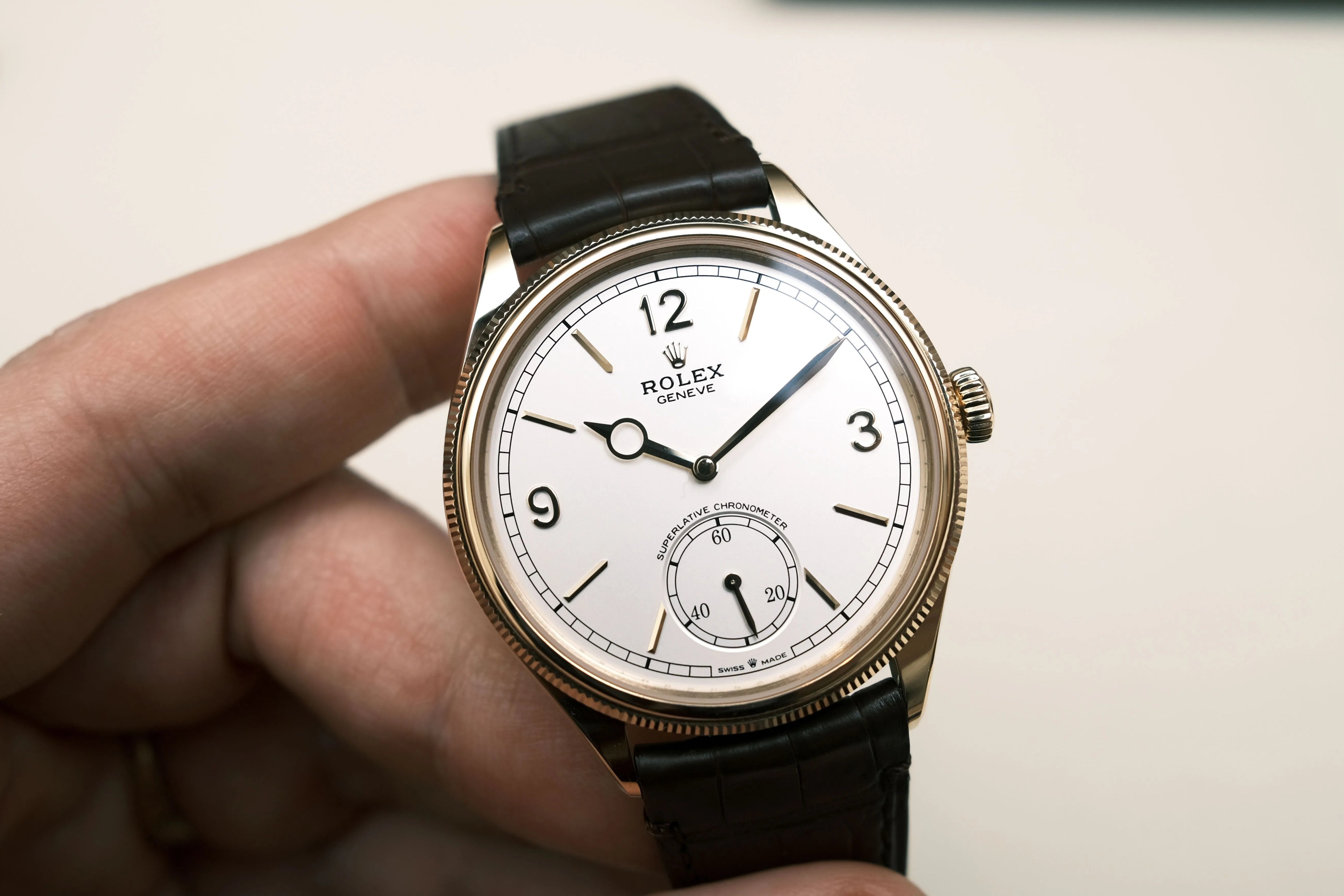 rolex dress watch held in hand